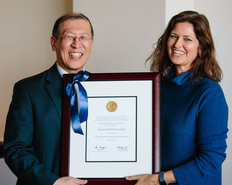 Dr. Averil Ma and Jen Rainin holding up a framed certificate honoring 10 years of Kenneth Rainin’s legacy at University of California, San Francisco in 2017.