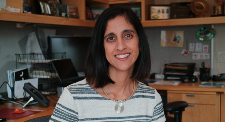 Tejal Desai seated in an office, smiling.