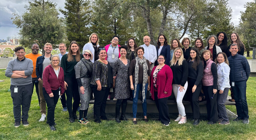 Kenneth Rainin Foundation staff pictured together outdoors, smiling at the camera.