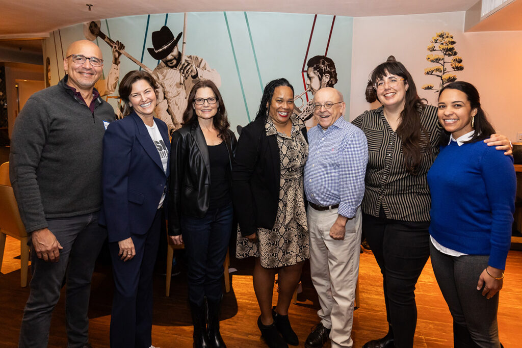 A group of people standing together and smiling