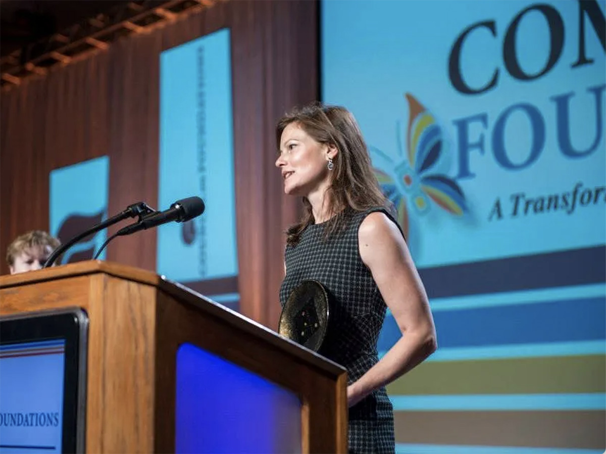 A woman speaking at a podium