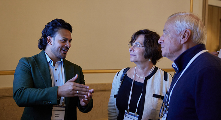 Three people talking animatedly.