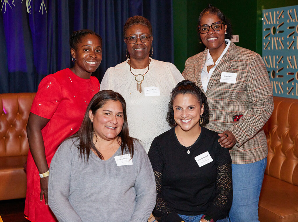 Five people smiling at the camera