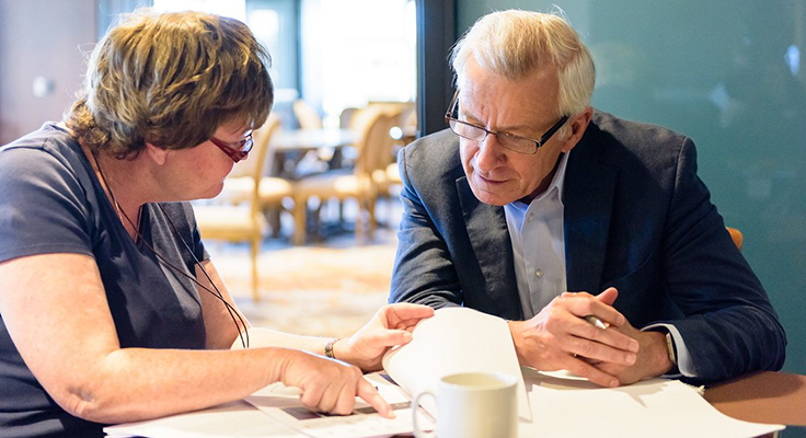 Doctors Fiona Powrie and Jean-Frederic Colombel sitting at a table working together.