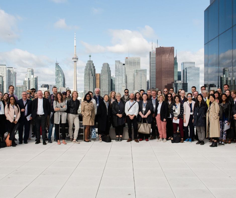 A large group of people in front of the Toronto city skyline.