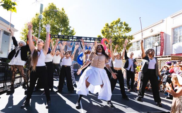 12 performers on an outdoor stage
