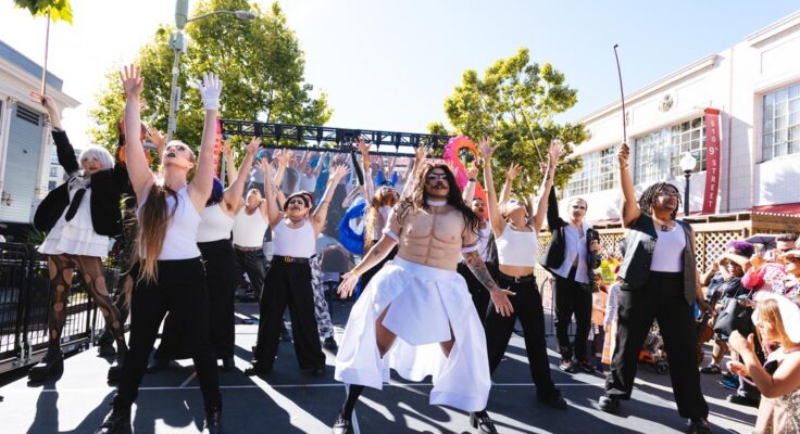 12 performers on an outdoor stage